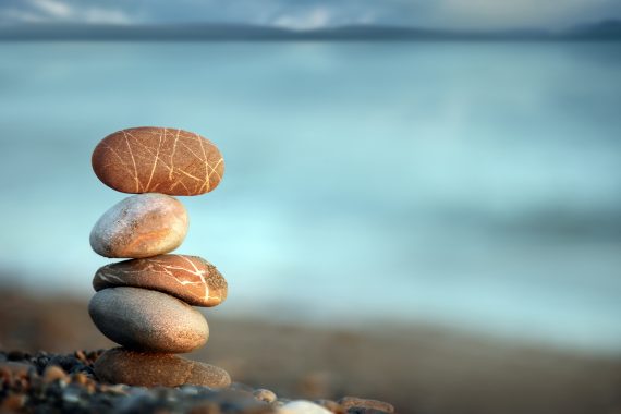 Rocks balanced one one on top of the other on the beach
