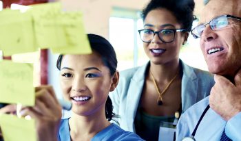 Medical professionals using sticky notes for brainstorming