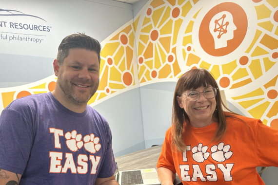 A man and woman wearing Clemson “Too Easy” t-shirts