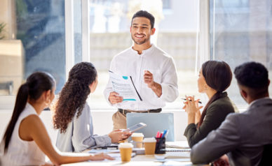 Staff, presentation and business man in a meeting, teamwork and planning with brainstorming, feedback and review. Presenter, group and team share ideas, collaboration and partnership with documents